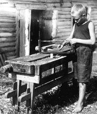 Boy doing woodwork at a pioneer camp, 1930s (Cicely Osmond Collection, SCRSS Photo Library)